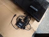 a television sitting on top of a cardboard box on the floor
