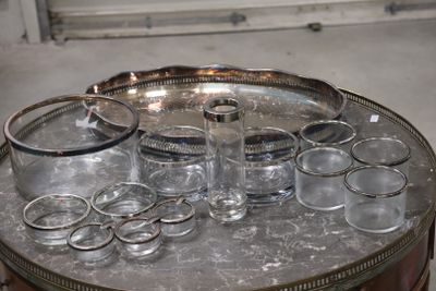 bottles and glasses on a silver tray on a table in a room