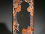 a picture of a picture of a mirror with leaves on it