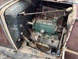 an old car that has a engine in it