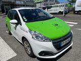 a green and white car parked on the side of the road