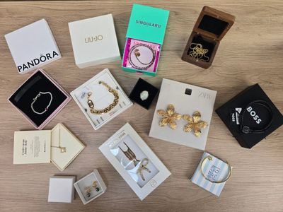 a lot of jewelry sitting on a wooden table