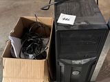 a computer sitting in a box next to a box of wires