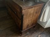 a wooden dresser with a vase on top of it