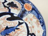 a blue and white plate with a fish design on it