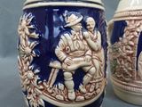 two beer mugs that are sitting on a table