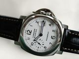 a close up of a wrist watch with a white dial