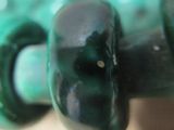 a close up of a skateboard with green wheels on it