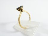 an image of a gold ring with a blue stone on top