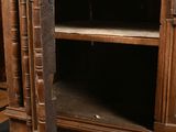 a wooden cabinet with a door open on a hard wood floor