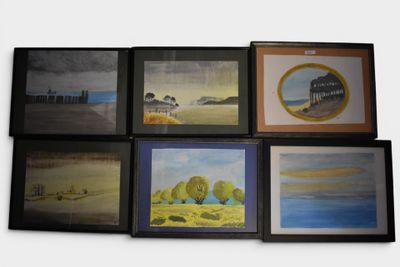 six framed pictures of different landscapes on the wall