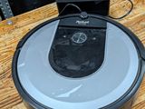 an image of a robotic vacuum cleaner sitting on a wooden table