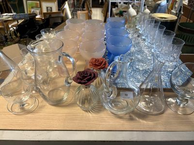 many glasses and vases on a table in a store