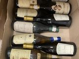 bottles of wine are in a cardboard box on a table