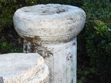 two cement pedestals sitting next to each other in a garden