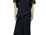 mannequin dressed in black dress with pleaed skirt on display