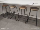 three stools that are sitting in front of a counter