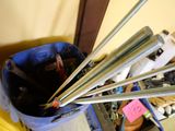 a blue bucket with four metal straws in it