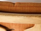a close up of a wooden chair with a cushion on it