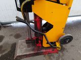a machine that is sitting on the ground in front of a building