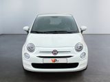 the front view of a white fiat car parked in a garage