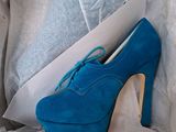 a box with a pair of blue high heels in it