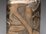 a close up of a metal object with leaves on it