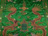 an image of a green and red oriental rug with dragon designs