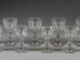 twelve crystal wine glasses lined up in a row