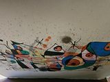 a painting on the ceiling of a room with a laptop on it