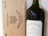 a bottle of wine sitting next to a wooden box
