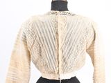 a woman ' s dress with a white jacket on a mannequin mannequin mannequin mann