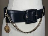 a close up of a mannequin torso wearing a belt with a chain around it