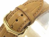 the watch is made of leather and has a gold buckle