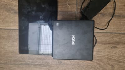 two laptops that are sitting on a wooden floor