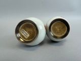 pair of white porcelain vases with gold rims on grey background