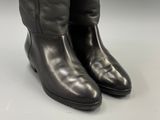 black leather boots with zippers on the side of them