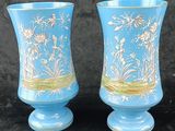 two vases that are sitting on a black surface