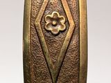 a bronze clock that is on display on a table
