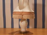 a lamp that is sitting on a table with a lamp shade on it