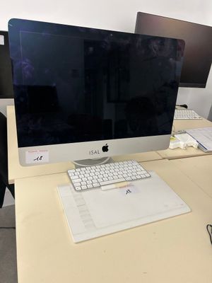 a desk with a computer monitor and keyboard on it