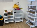 a room with a staircase and shelves in it