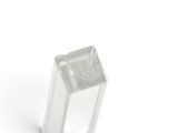 a clear glass object on a white surface with a white background