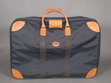 an image of a black and orange suitcase on a grey background