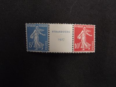 a close up of two stamps on a black surface