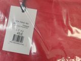 a red shirt with a tag on it in a plastic bag