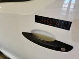 a close up of a car door handle with a sticker on it