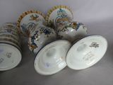 several cups and saucers are lined up on a white surface