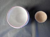 a cup and saucer sitting on a table next to each other
