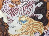 a picture of a tiger and a tiger cub laying on a blanket